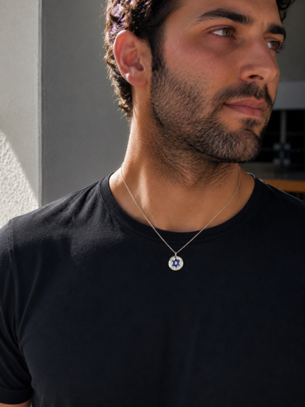 Round Star Of Israel tag — sterling silver on model